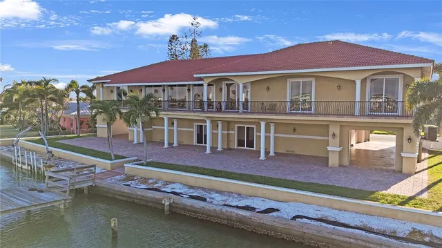 a balcony with table and chairs