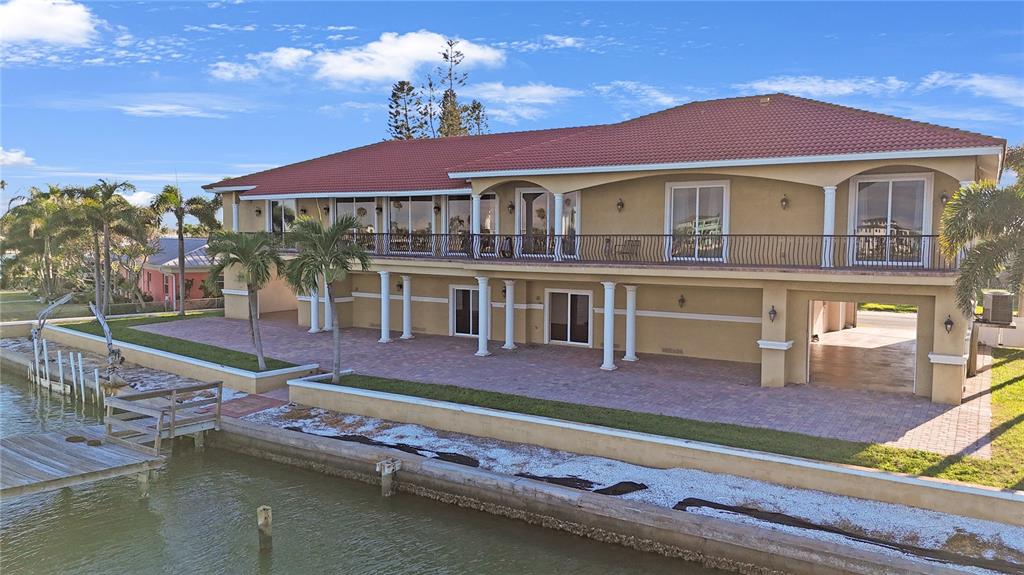 736 Pruitt Drive Madeira Beach, FL 33708 - Photo 42 of 42 a balcony with table and chairs