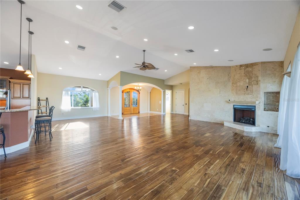 736 Pruitt Drive Madeira Beach, FL 33708 - Photo 8 of 42 a view of empty room with wooden floor and fireplace