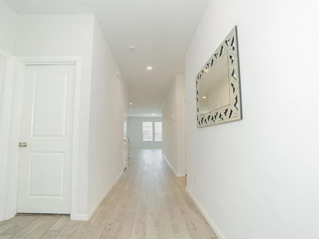 a view of a hallway with wooden floor