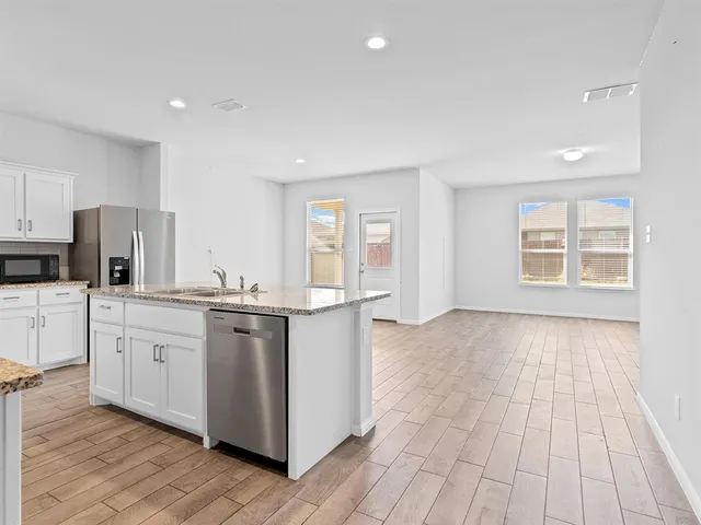 a kitchen with stainless steel appliances granite countertop a stove and a sink