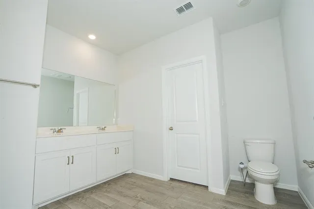 a view of bathroom with a toilet sink and mirror