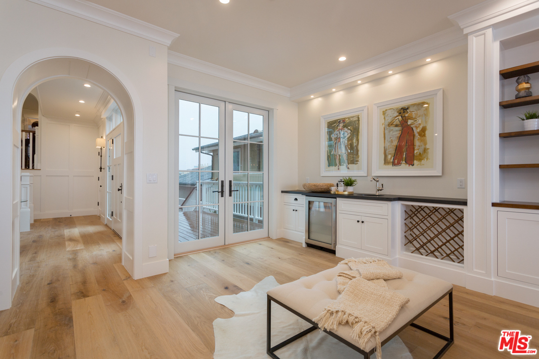 861 Mandalay Beach Road Oxnard, CA 93035 - Photo 11 of 31 a view of a hallway with wooden floor and a living room