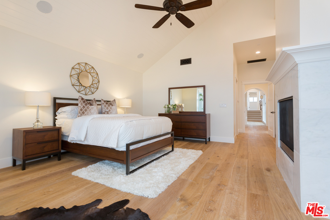 861 Mandalay Beach Road Oxnard, CA 93035 - Photo 16 of 31 a bedroom with a bed and a chandelier