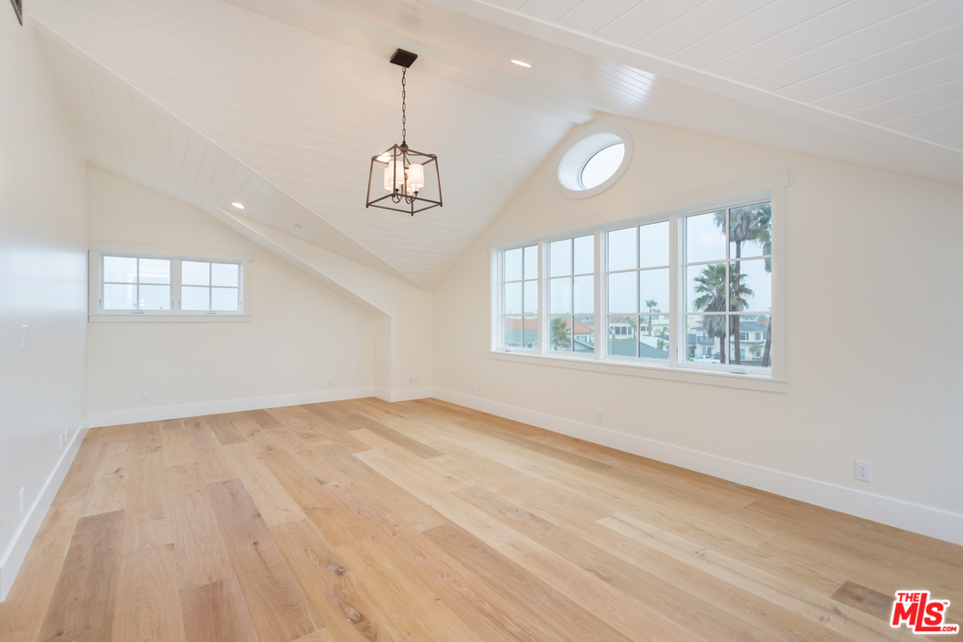 861 Mandalay Beach Road Oxnard, CA 93035 - Photo 25 of 31 a view of an empty room with a window and wooden floor