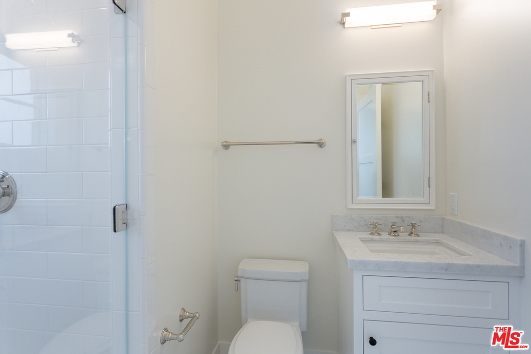 861 Mandalay Beach Road Oxnard, CA 93035 - Photo 29 of 31 a bathroom with a granite countertop sink a toilet and shower