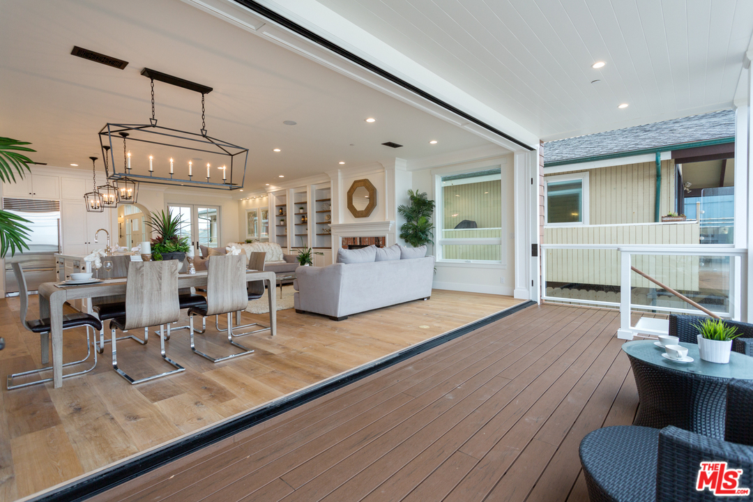 861 Mandalay Beach Road Oxnard, CA 93035 - Photo 7 of 31 a view of a living room and kitchen floor to ceiling window and wooden floor