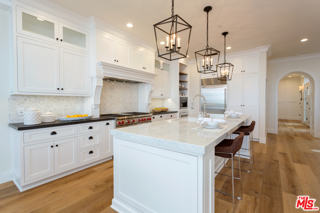 861 Mandalay Beach Road Oxnard, CA 93035 - Photo 10 of 31 a kitchen with kitchen island granite countertop a sink a counter space and cabinets