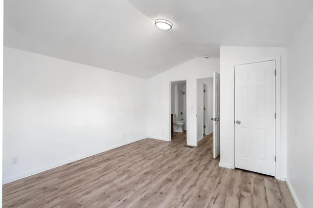 a view of a room with wooden floor