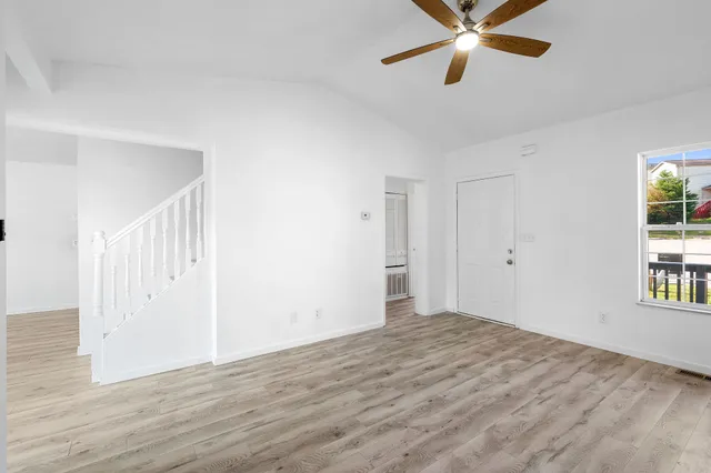 a view of a room with wooden floor and windows