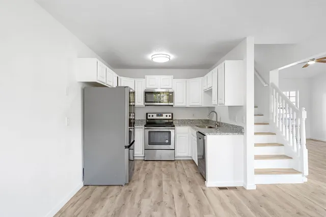 a kitchen with stainless steel appliances a refrigerator and a stove top oven