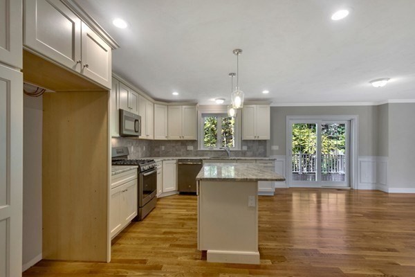 11 Wilson Road Berlin, MA 01503 - Photo 8 of 15 a kitchen with kitchen island a stove a sink a refrigerator and a dining table with wooden floor