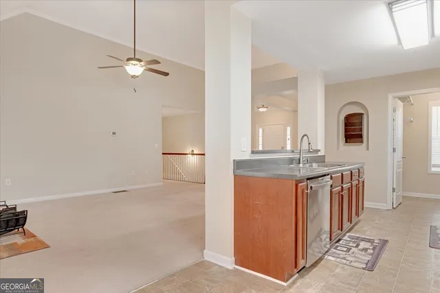 a bathroom with a granite countertop sink a mirror and shower