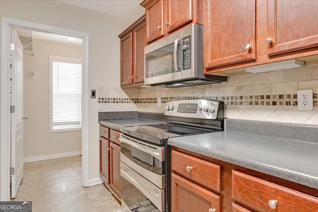 a kitchen with stainless steel appliances granite countertop a sink and a stove