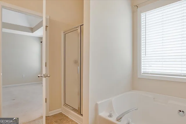 a bathroom with a bathtub and shower