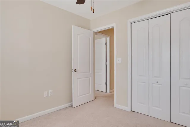 an empty room with a ceiling fan