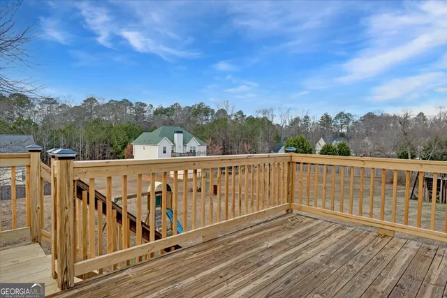 a view of a balcony with wooden fence