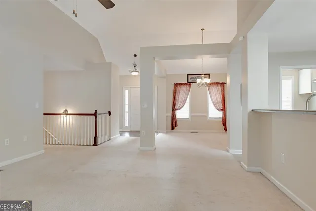 a view of a kitchen with a refrigerator and cabinets