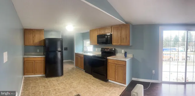 a kitchen with stainless steel appliances granite countertop a refrigerator stove and oven