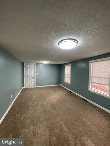 an empty room with a empty space and windows