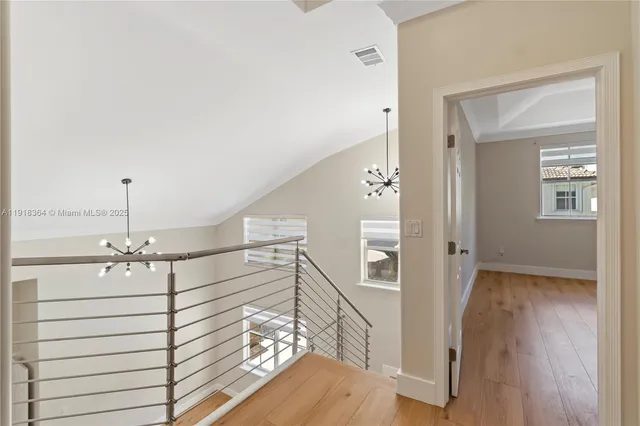 a view of a hallway with closet and wooden floor