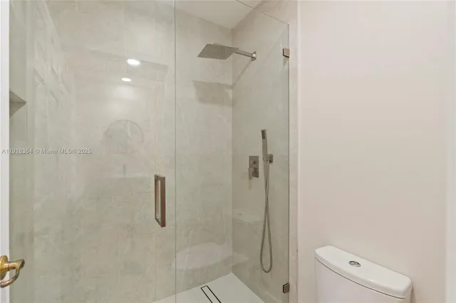 a bathroom with a shower and toilet