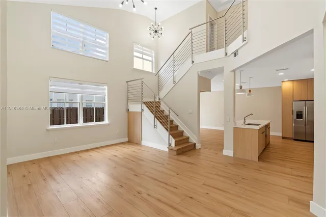 a view of an entryway with wooden floor and a front door