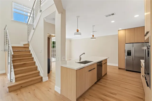 a kitchen with a sink and refrigerator