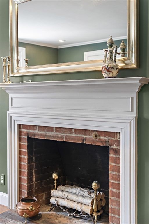 82 Risley Road Brookline, MA 02467 - Photo 12 of 20 a living room with a fireplace and a table