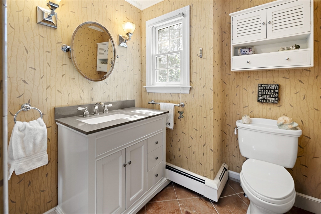 82 Risley Road Brookline, MA 02467 - Photo 13 of 20 a bathroom with a granite countertop toilet sink and a mirror