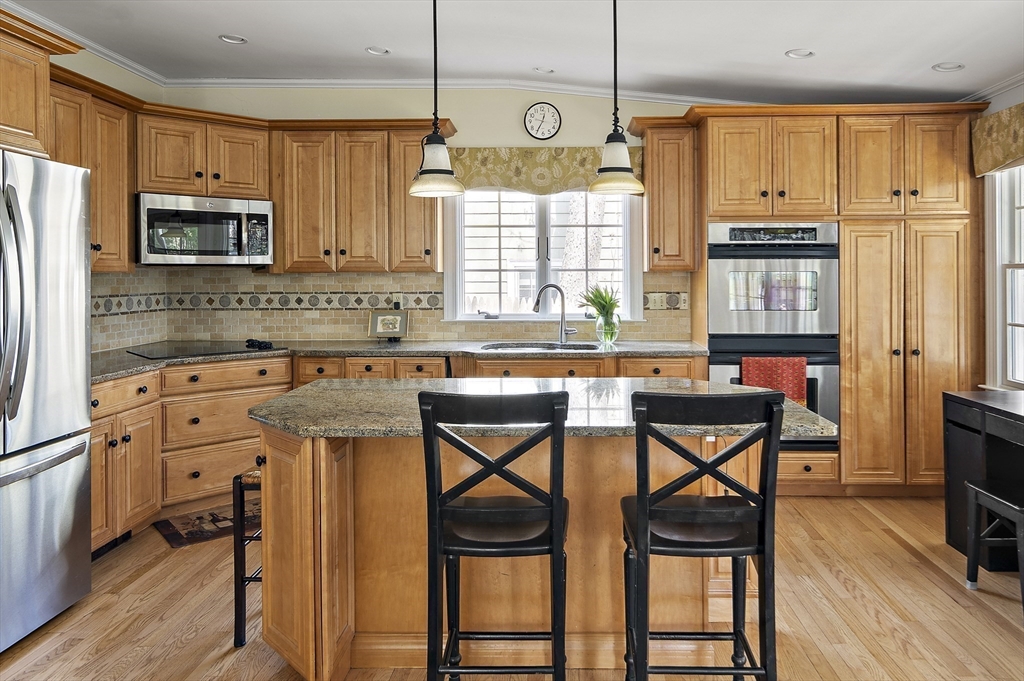 82 Risley Road Brookline, MA 02467 - Photo 6 of 20 a kitchen with stainless steel appliances granite countertop a stove a sink and a refrigerator