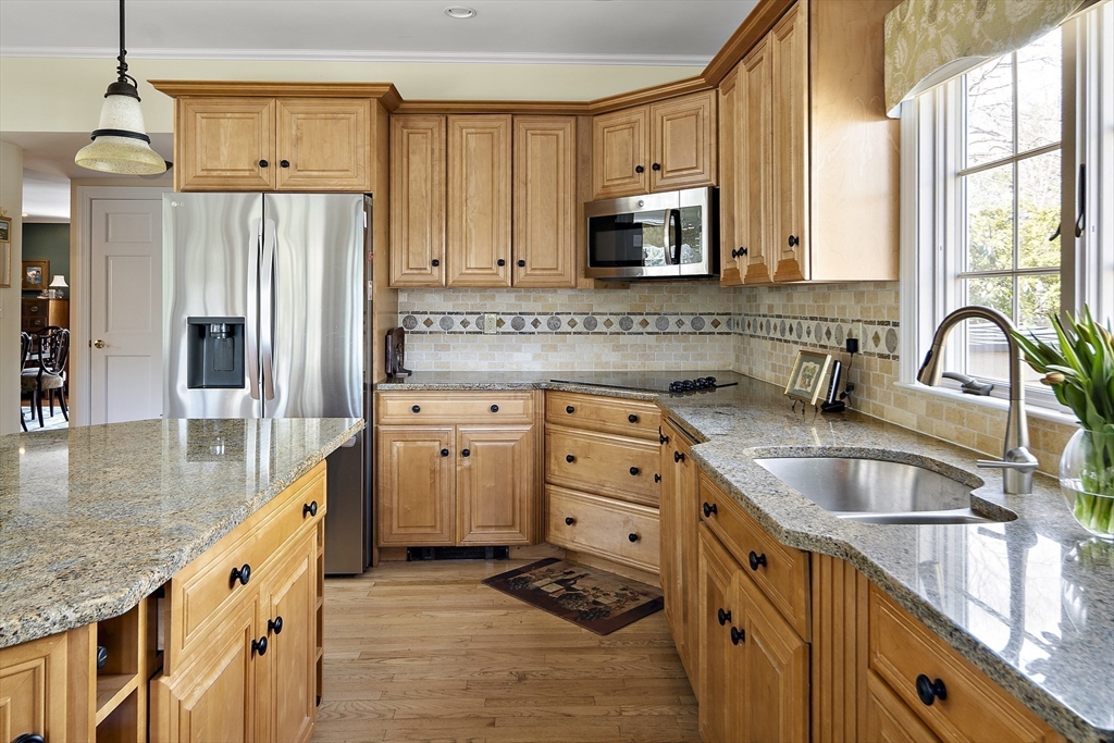 82 Risley Road Brookline, MA 02467 - Photo 7 of 20 a kitchen with stainless steel appliances granite countertop a sink stove and refrigerator