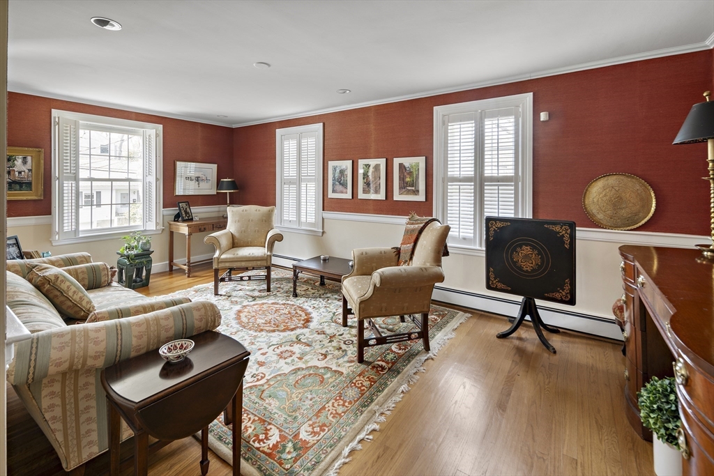 82 Risley Road Brookline, MA 02467 - Photo 9 of 20 a living room with furniture a rug and wooden floor