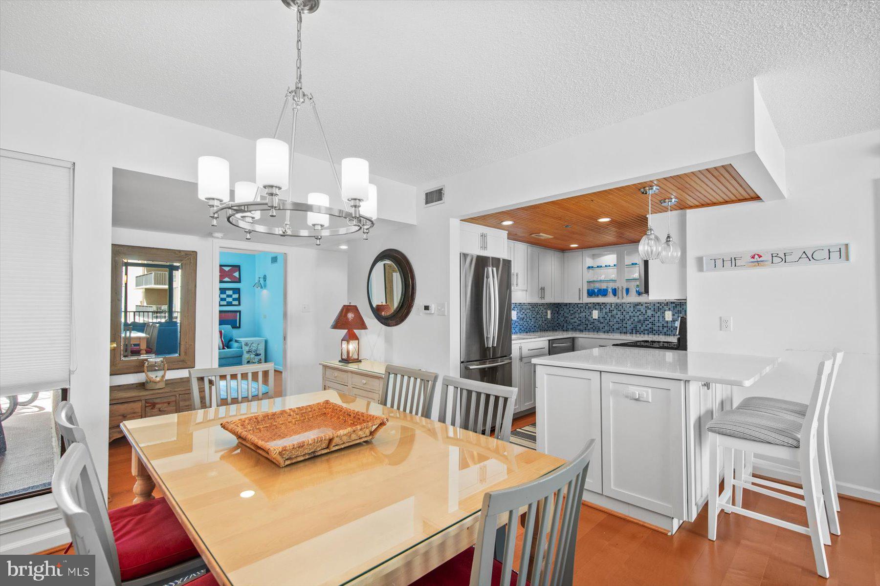 312 Island House Road Bethany Beach, DE 19930 - Photo 12 of 48 a kitchen with a table and chairs in it