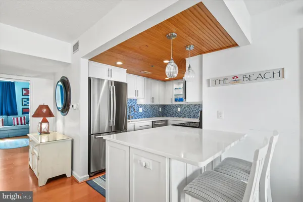 a kitchen with stainless steel appliances a refrigerator and a stove