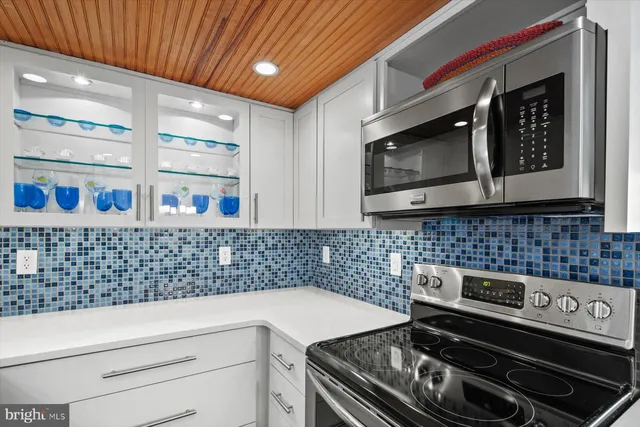 a kitchen that has a stove and a table