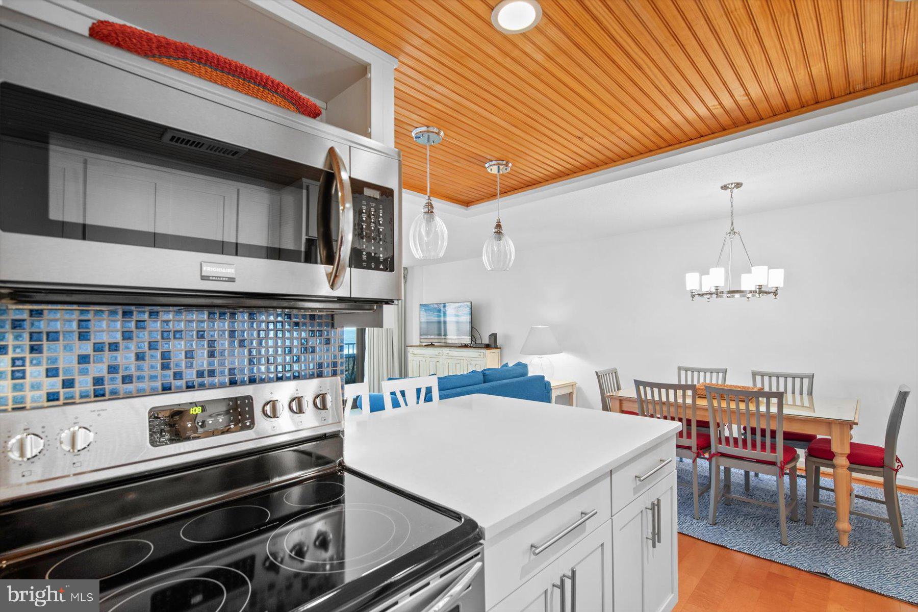 312 Island House Road Bethany Beach, DE 19930 - Photo 20 of 48 a kitchen that has a stove and a table