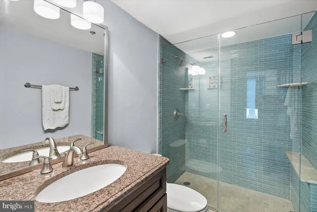 a bathroom with a granite countertop sink a vanity and a mirror