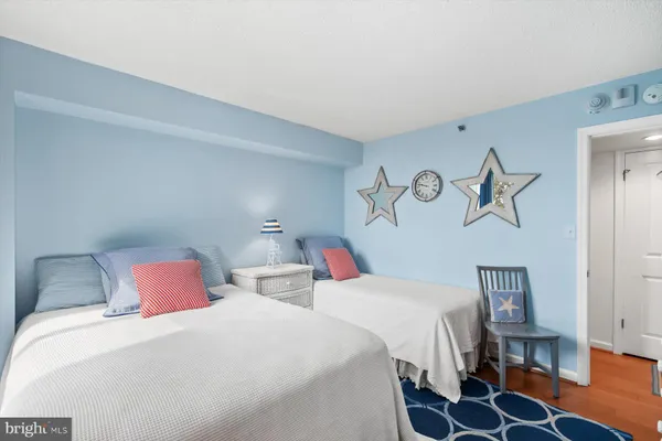 a bedroom with two beds and painted walls