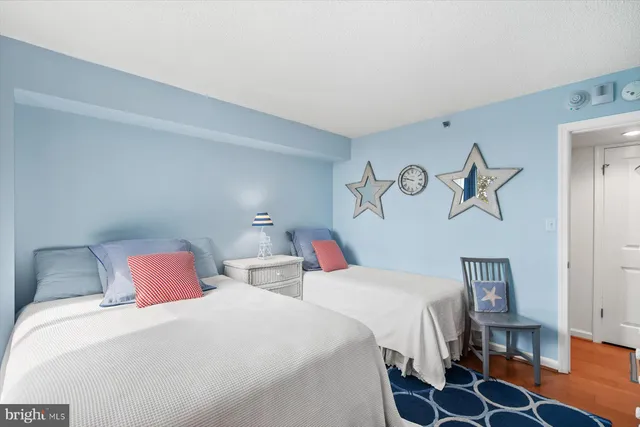 a bedroom with two beds and painted walls