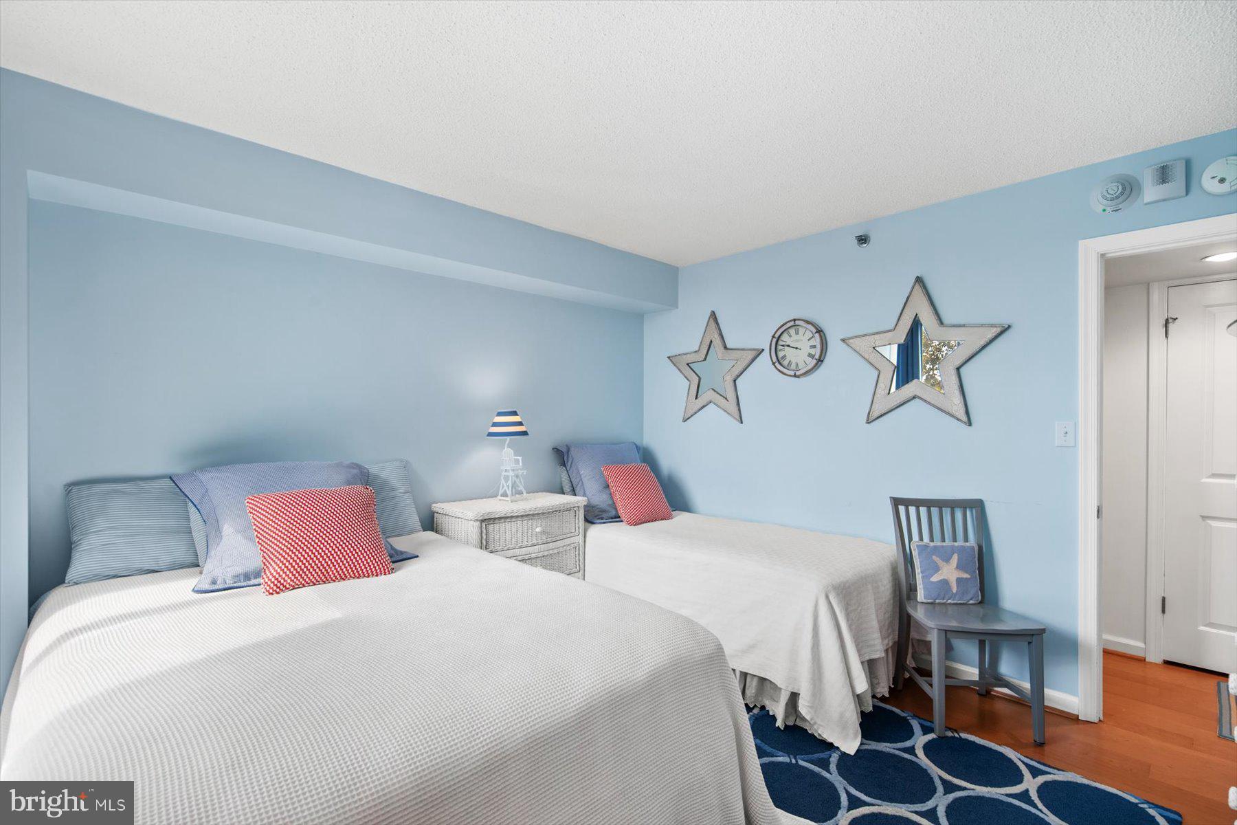 312 Island House Road Bethany Beach, DE 19930 - Photo 30 of 48 a bedroom with two beds and a lamp on dresser