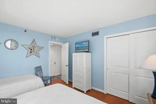 a view of room with hardwood floor and cabinet