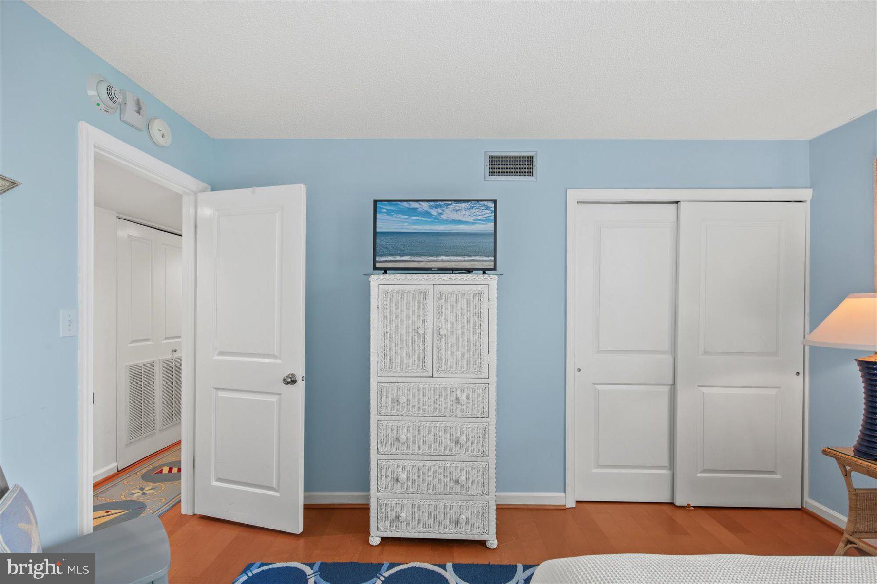 312 Island House Road Bethany Beach, DE 19930 - Photo 32 of 48 a view of room with hardwood floor and cabinet