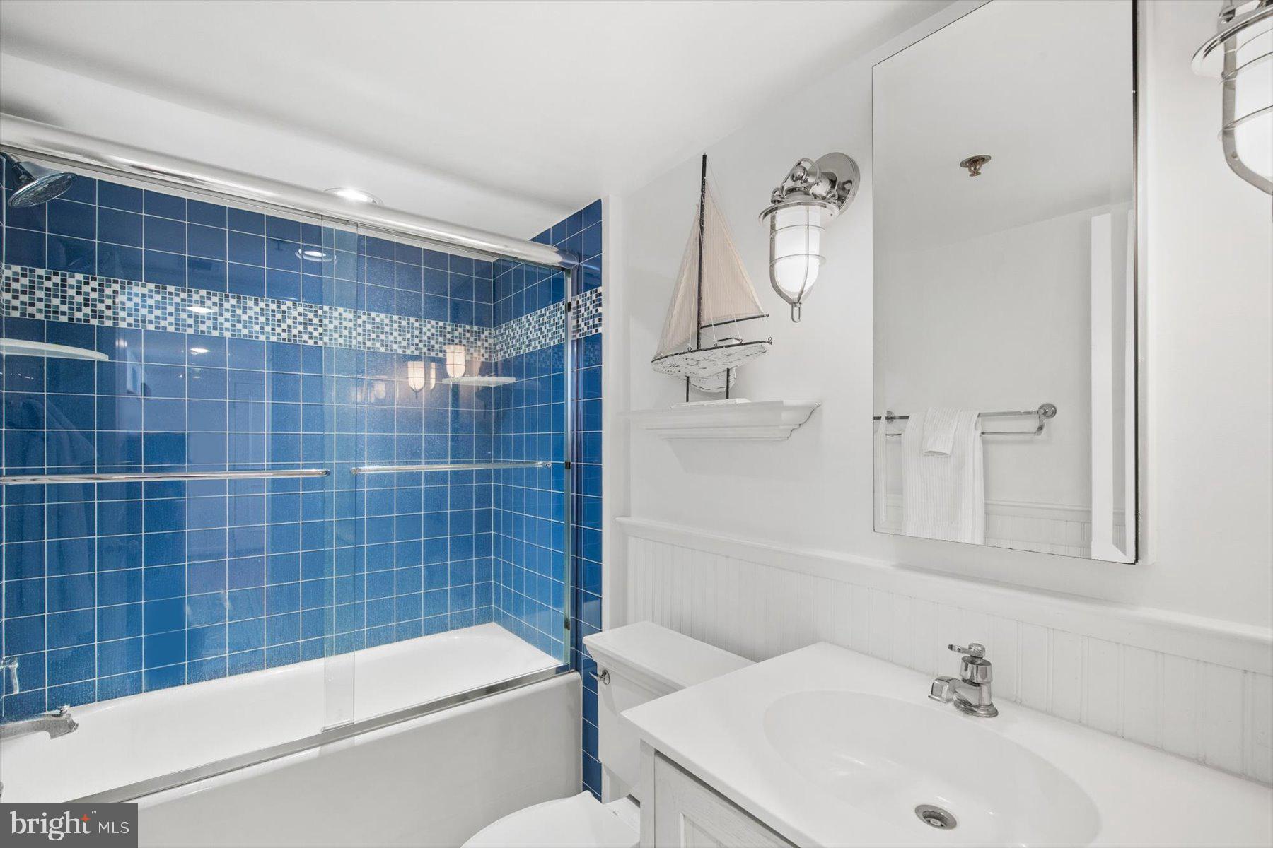 312 Island House Road Bethany Beach, DE 19930 - Photo 33 of 48 a bathroom with a sink a toilet and shower