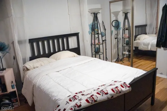 a bed sitting in a bedroom next to a window