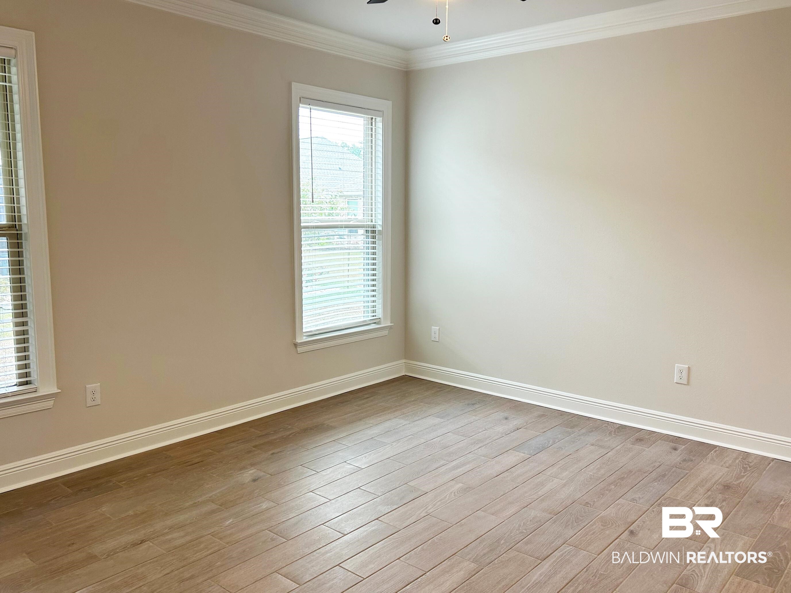 873 Sumter Loop Foley, AL 36535 - Photo 13 of 26 Empty room featuring light wood-style floors, crown molding, and ceiling fan
