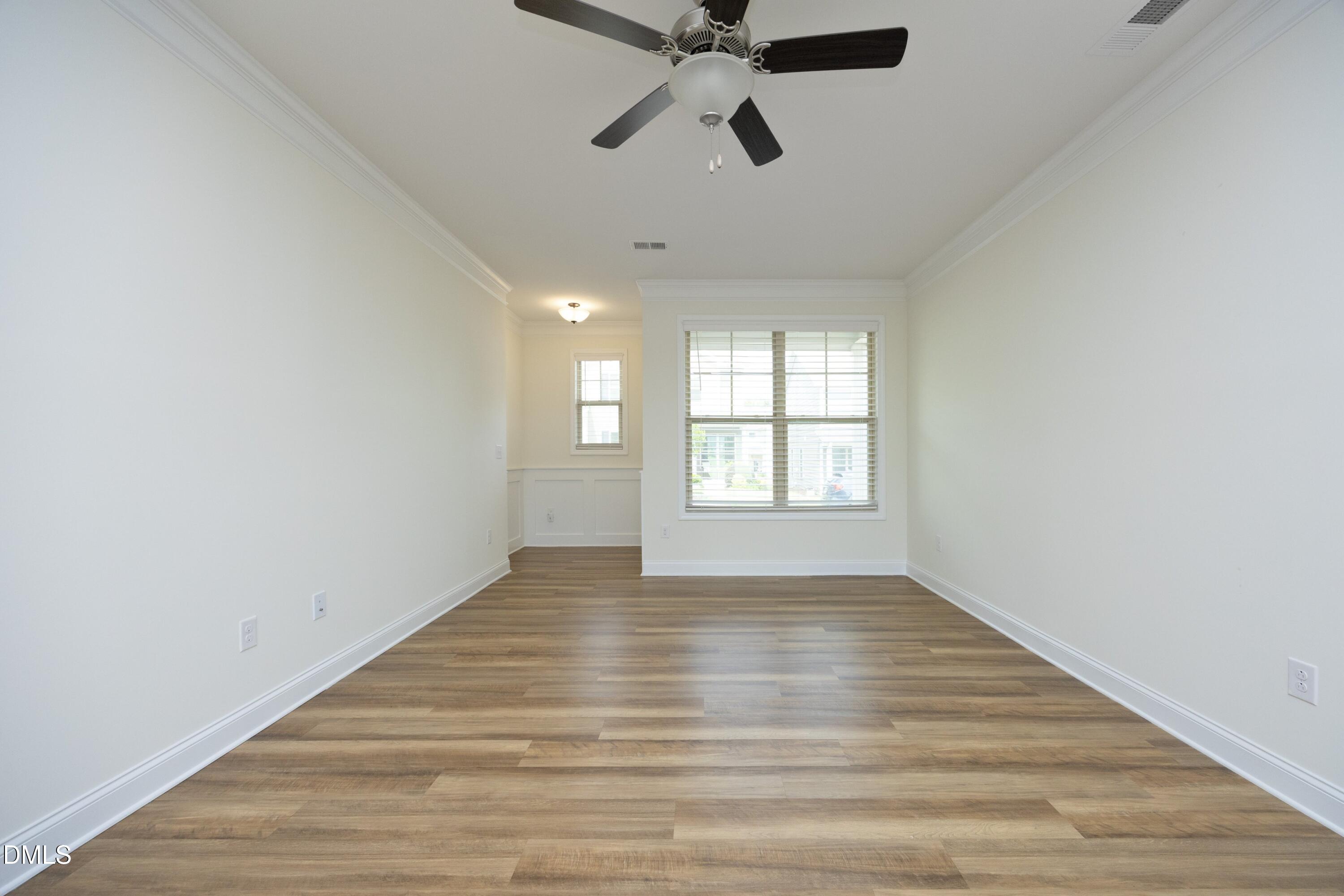 824 Country Downs Road Wake Forest, NC 27587 - Photo 12 of 41 wooden floor in an empty room with a window