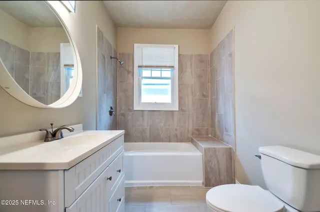 a bathroom with a sink a toilet and bathtub