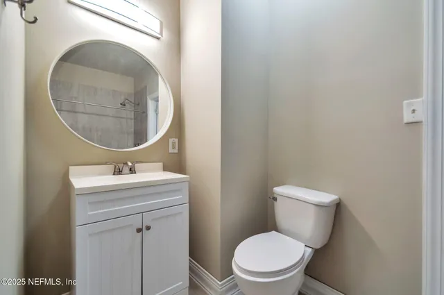 a bathroom with a toilet a sink and mirror