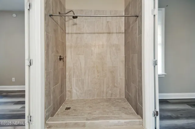 a bathroom with a glass door shower